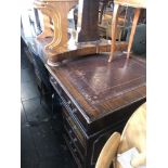 A large mahogany leather top pedestal desk