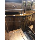 A three drawer sideboard and a elbow chair