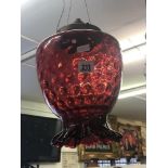 A cranberry glass hanging lamp shade