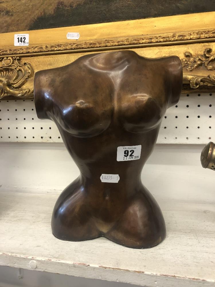 A bronze female torso