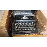 A vintage portable typewriter and stationary