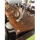 A contemporary extending dining table with two leaves,