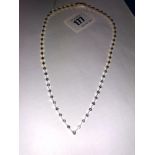 An 18ct gold two tone necklace with twenty-three diamond,