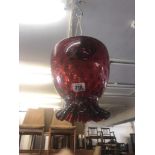 A cranberry glass hanging lamp shade