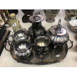 A five piece silver plated set on a tray