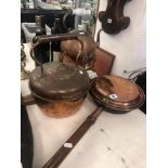 A brass bedpan and two old kettles