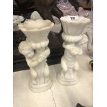 A pair of marble cherub candlesticks