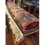 A decorative red ground Persian rug,