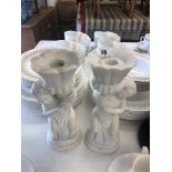 A pair of marble cherub candlesticks