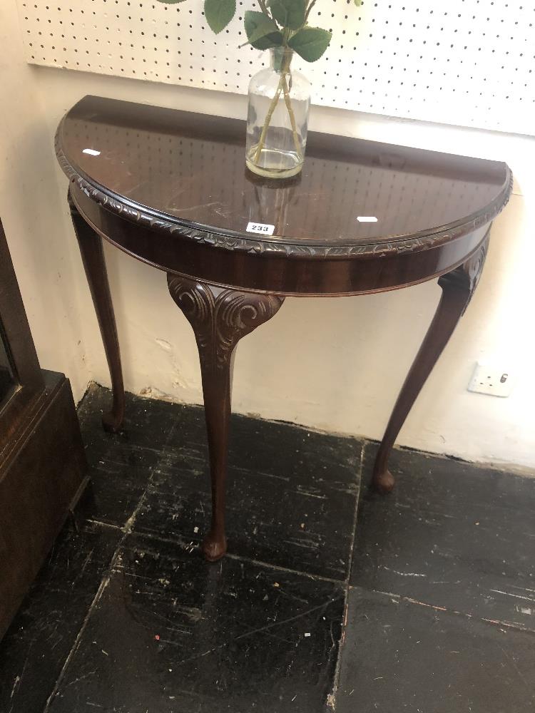 A demi lune hall table