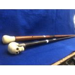 A silver handled walking stick bone skull top plus another