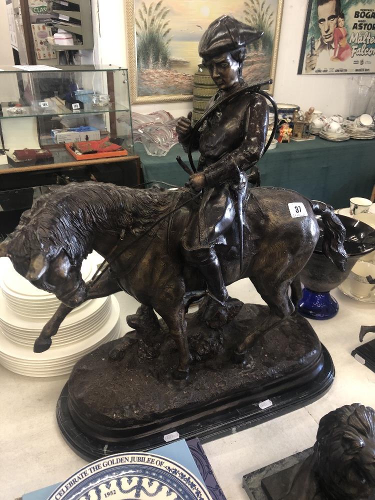 A bronze huntsman on a horse