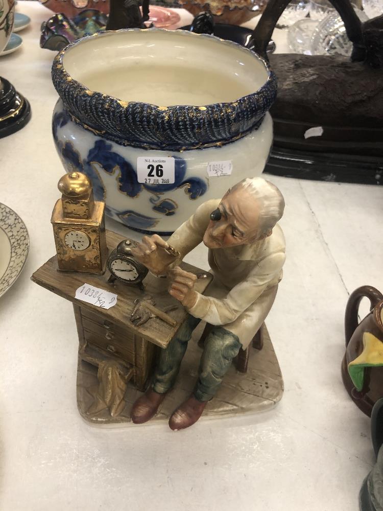 A blue and white jardiniere and a figure 'Watchmaker'