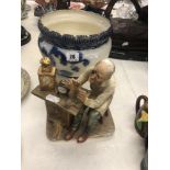 A blue and white jardiniere and a figure 'Watchmaker'