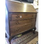 An oak bureau with three drawers