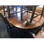 A mahogany extending dining table with two leaves