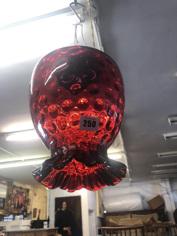 A cranberry glass hanging lamp shade
