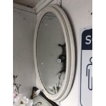 An oval painted mirror