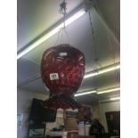 A cranberry glass hanging lamp shade