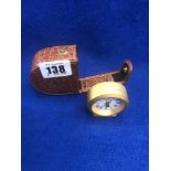 A cased travel clock,
