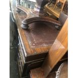 A large mahogany leather top pedestal desk