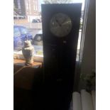 An art deco grandfather clock with pendulum weights and key