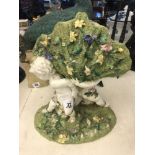 A green and white centre piece with cherubs,