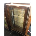 A Walnut single door display cabinet