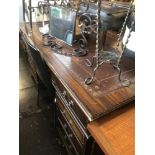 A large mahogany leather top pedestal desk