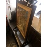 An oak framed needlework fire screen