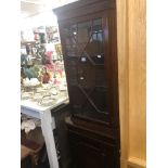 A mahogany corner cabinet