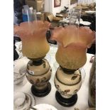 A pair of Victorian oil lamps with shades
