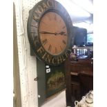 A painted wall clock 'Finchley coach stop' retrieved from a local pub,