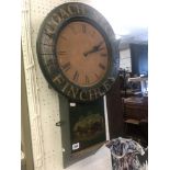 A painted wall clock 'Finchley coach stop' retrieved from a local pub,