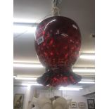 A cranberry glass hanging lamp shade