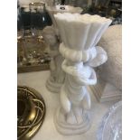 A pair of marble cherub candlesticks