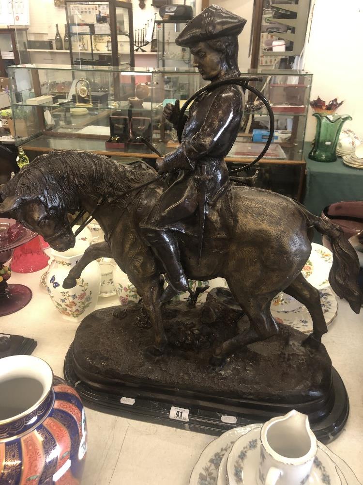 A bronze huntsman on a horse