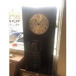 An art deco grandfather clock with pendulum weights and key
