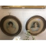 A pair of small oval portrait photos