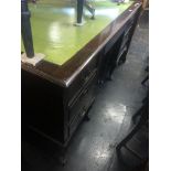 A large mahogany leather top desk