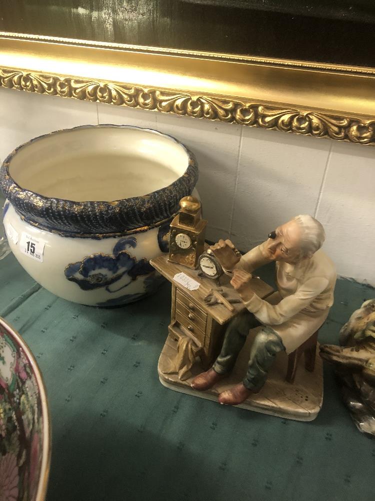 A blue and white jardiniere and a figure 'Watchmaker'