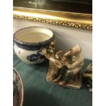 A blue and white jardiniere and a figure 'Watchmaker'