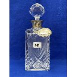 A silver rimmed decanter with hm silver Whisky label