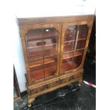 A Walnut bookcase with two drawers under