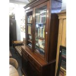 A Victorian walnut bookcase on cupboard base