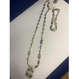 A silver necklace and a bracelet