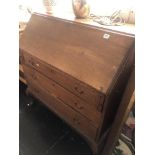 An oak bureau with three drawers