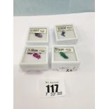 Four boxes of loose gemstones; emeralds,