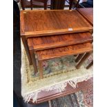 A rosewood nest of three tables