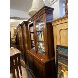 A Victorian walnut bookcase on cupboard base